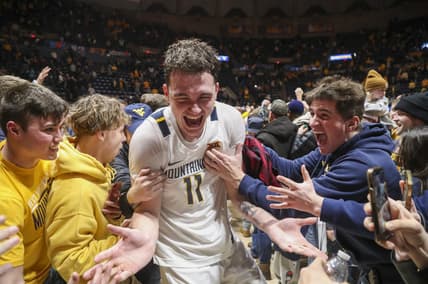 Jan 20, 2024; Morgantown, West Virginia, USA; West Virginia Mountaineers forward Quinn Slazinski (11) celebrates with students after defeating the Kansas Jayhawks at WVU Coliseum. Mandatory Credit: Ben Queen-USA TODAY Sports