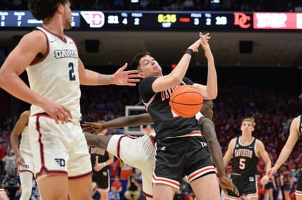 Feb 27, 2024; Dayton, Ohio, USA;  Davidson Wildcats guard Riccardo Ghedini (22) reaches for a rebound against Dayton Flyers forward Nate Santos (2) during the game at University of Dayton Arena. Mandatory Credit: Matt Lunsford-USA TODAY Sports