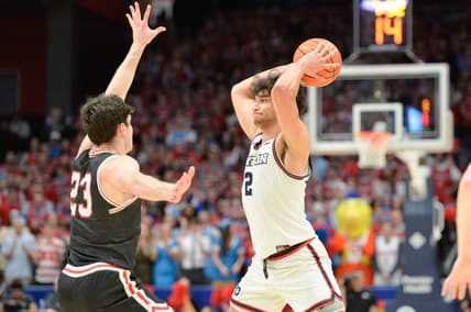 Feb 27, 2024; Dayton, Ohio, USA;  Dayton Flyers forward Nate Santos (2) passes the ball against Davidson Wildcats guard Connor Kochera (23) during the second half of the game at University of Dayton Arena. Mandatory Credit: Matt Lunsford-USA TODAY Sports