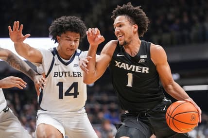 Xavier Musketeers guard Desmond Claude (1) rushes past Butler Bulldogs guard Landon Moore (14) on Wednesday, March 6, 2024, during the game at Hinkle Fieldhouse in Indianapolis. The Butler Bulldogs defeated the Xavier Musketeers, 72-66.