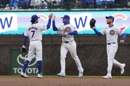 Apr 1, 2024; Chicago, Illinois, USA; Chicago Cubs shortstop Dansby Swanson (7), left fielder Ian Happ (8), and center fielder Cody Bellinger (24) celebrate their win against the Colorado Rockies at Wrigley Field. Mandatory Credit: David Banks-USA TODAY Sports