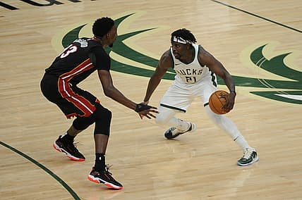 May 15, 2021; Milwaukee, Wisconsin, USA;  Miami Heat center Bam Adebayo (13) guards Milwaukee Bucks guard Jrue Holiday (21) in the third quarter at Fiserv Forum. Mandatory Credit: Michael McLoone-USA TODAY Sports