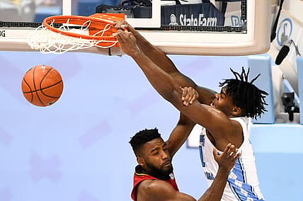 Feb 20, 2021; Chapel Hill, North Carolina, USA;  North Carolina Tar Heels forward Day'Ron Sharpe (11) scores as Louisville Cardinals guard Charles Minlend (21) defends in the second half at Dean E. Smith Center. Mandatory Credit: Bob Donnan-USA TODAY Sports