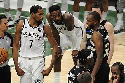 Jun 17, 2021; Milwaukee, Wisconsin, USA; Brooklyn Nets forward Kevin Durant (7) speaks with Milwaukee Bucks forward Khris Middleton (22) after a hard foul on forward Giannis Antetokounmpo (not pictured) in the fourth quarter during game six in the second round of the 2021 NBA Playoffs at Fiserv Forum. Mandatory Credit: Michael McLoone-USA TODAY Sports