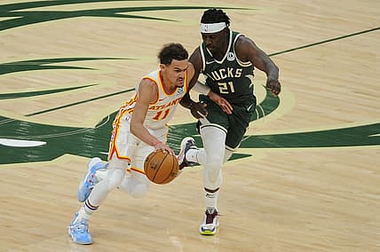 Jun 23, 2021; Milwaukee, Wisconsin, USA; Atlanta Hawks guard Trae Young (11) drives to the basket against Milwaukee Bucks guard Jrue Holiday (21) in the third quarter during game one of the Eastern Conference Finals for the 2021 NBA Playoffs at Fiserv Forum. Mandatory Credit: Michael McLoone-USA TODAY Sports