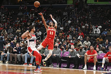 Oct 28, 2021; Washington, District of Columbia, USA;  Atlanta Hawks guard Trae Young (11) shoots as Washington Wizards guard Raul Neto (19) defends during the first half at Capital One Arena. Mandatory Credit: Tommy Gilligan-USA TODAY Sports