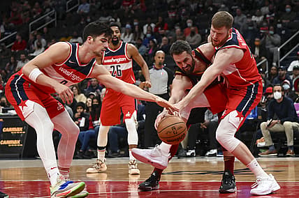 Dec 3, 2021; Washington, District of Columbia, USA;  Cleveland Cavaliers forward Kevin Love (0) riches for a loose ball in between Washington Wizards forward Deni Avdija (9) and forward Davis Bertans (42) during the first half at Capital One Arena. Mandatory Credit: Tommy Gilligan-USA TODAY Sports