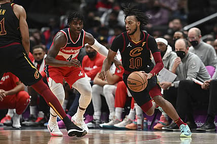 Dec 3, 2021; Washington, District of Columbia, USA;  Cleveland Cavaliers guard Darius Garland (10) dribbles as Washington Wizards guard Aaron Holiday (4) defends during the second half at Capital One Arena. Mandatory Credit: Tommy Gilligan-USA TODAY Sports