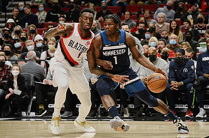 Dec 12, 2021; Portland, Oregon, USA; Minnesota Timberwolves forward Anthony Edwards (1) drives to the basket during the first half against Portland Trail Blazers forward Nassir Little (9) at Moda Center. Mandatory Credit: Troy Wayrynen-USA TODAY Sports