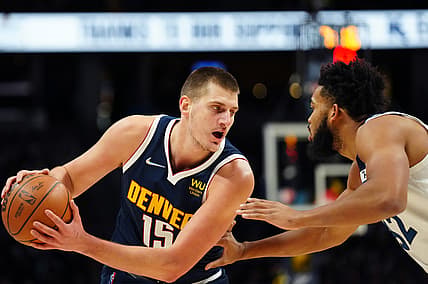 Dec 15, 2021; Denver, Colorado, USA; Denver Nuggets center Nikola Jokic (15) and Minnesota Timberwolves center Karl-Anthony Towns (32) during the first quarter at Ball Arena. Mandatory Credit: Ron Chenoy-USA TODAY Sports