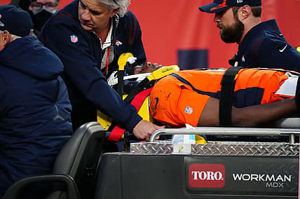 Dec 19, 2021; Denver, Colorado, USA; Denver Broncos quarterback Teddy Bridgewater (5) is carted off the field in the third quarter against the Cincinnati Bengals at Empower Field at Mile High Mandatory Credit: Ron Chenoy-USA TODAY Sports