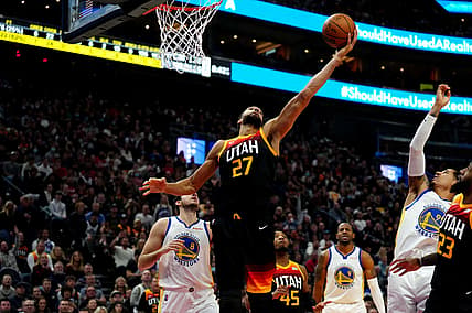 Jan 1, 2022; Salt Lake City, Utah, USA; Utah Jazz center Rudy Gobert (27) pulls in a rebound in the second half against the Golden State Warriors at Vivint Arena. Mandatory Credit: Ron Chenoy-USA TODAY Sports