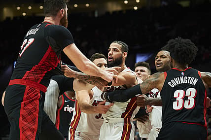 Jan 5, 2022; Portland, Oregon, USA; Miami Heat forward Caleb Martin (16) separates Portland Trail Blazers center Jusuf Nurkic (27) from guard Tyler Herro (14) during the second half at Moda Center. The Heat won the game 115-109. Mandatory Credit: Troy Wayrynen-USA TODAY Sports