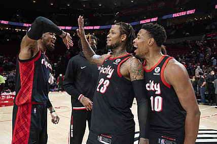 Jan 10, 2022; Portland, Oregon, USA; Portland Trail Blazers forward Robert Covington (33) celebrates with guard Ben McLemore (23) and guard Dennis Smith Jr. (10) after a game against the Brooklyn Nets at Moda Center. The Trail Blazers won the game 114-108. Mandatory Credit: Troy Wayrynen-USA TODAY Sports