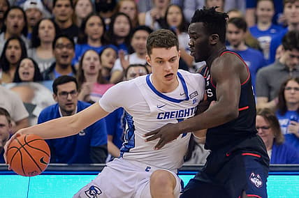 Mar 2, 2022; Omaha, Nebraska, USA; Creighton Bluejays center Ryan Kalkbrenner (11) drives against Connecticut Huskies forward Adama Sanogo (21) in the first half at CHI Health Center Omaha. Mandatory Credit: Steven Branscombe-USA TODAY Sports