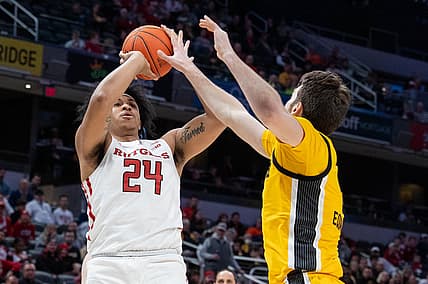 Mar 11, 2022; Indianapolis, IN, USA; Rutgers Scarlet Knights forward Ron Harper Jr. (24) shoots the ball while Iowa Hawkeyes guard Connor McCaffery (30) defends in the second half at Gainbridge Fieldhouse. Mandatory Credit: Trevor Ruszkowski-USA TODAY Sports