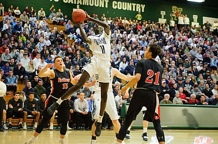 MMU's Taylor Bowen (11) leaps for lay up during the boys DI semi final basketball game between the Rutland Raiders and the Mount Mansfield Cougars at Patrick Gym on Monday night March 11, 2019 in Burlington, Vermont.

Rutland Vs Mmu Boys Basketball 03 11 19