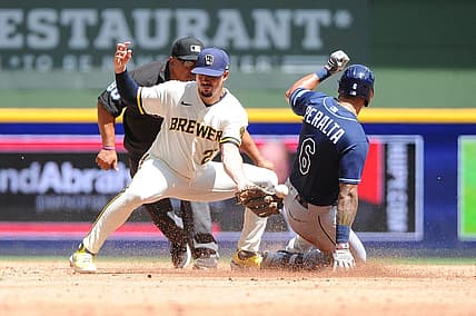 Aug 10, 2022; Milwaukee, Wisconsin, USA; Milwaukee Brewers shortstop Willy Adames (27) is unable make the play as Tampa Bay Rays left fielder David Peralta (6) slides in safely in the third inning  at American Family Field. Mandatory Credit: Michael McLoone-USA TODAY Sports