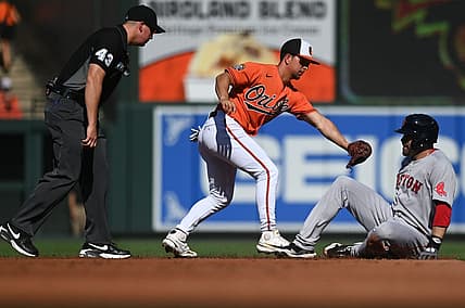 Aug 20, 2022; Baltimore, Maryland, USA;  Boston Red Sox designated hitter J.D. Martinez (28) leans back to avoid Baltimore Orioles second baseman Ramon Urias (29) tag for a second inning double at Oriole Park at Camden Yards. Mandatory Credit: Tommy Gilligan-USA TODAY Sports