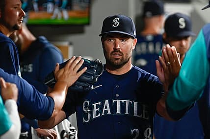 Aug 23, 2022; Seattle, Washington, USA; Seattle Mariners starting pitcher Robbie Ray (38) celebrates in the dugout after striking out the side in the sixth inning at T-Mobile Park. Mandatory Credit: Steven Bisig-USA TODAY Sports