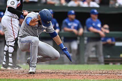 Sep 5, 2022; Baltimore, Maryland, USA;  Toronto Blue Jays left fielder Lourdes Gurriel Jr. (13) slides to score during the ninth inning against the Baltimore Orioles at Oriole Park at Camden Yards. Mandatory Credit: Tommy Gilligan-USA TODAY Sports