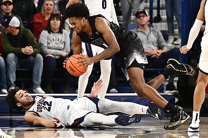 Dec 9, 2022; Spokane, Washington, USA; Gonzaga Bulldogs forward Anton Watson (22) takes the charge from Washington Huskies forward Keion Brooks (1) in the second half at McCarthey Athletic Center. Gonzaga won 77-60. Mandatory Credit: James Snook-USA TODAY Sports