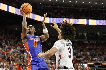 Dec 28, 2022; Auburn, Alabama, USA;  Florida Gators guard Kyle Lofton (11) gets past Auburn Tigers guard Tre Donaldson (3) for a shot during the first half at Neville Arena. Mandatory Credit: John Reed-USA TODAY Sports