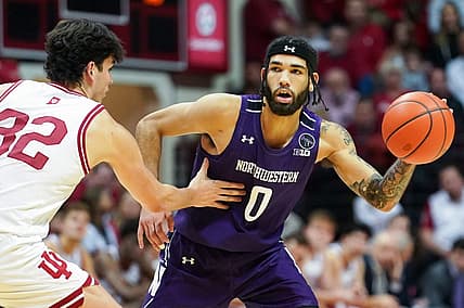 Jan 8, 2023; Bloomington, Indiana, USA;  Northwestern Wildcats guard Boo Buie (0) passes the ball around Indiana Hoosiers guard Trey Galloway (32) during the second half at Simon Skjodt Assembly Hall. Mandatory Credit: Robert Goddin-USA TODAY Sports