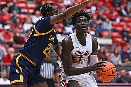 Jan 11, 2023; Pullman, Washington, USA; Washington State Cougars forward Mouhamed Gueye (35) shoots the ball against California Golden Bears forward Obinna Anyanwu (23) in the first half at Friel Court at Beasley Coliseum. Mandatory Credit: James Snook-USA TODAY Sports