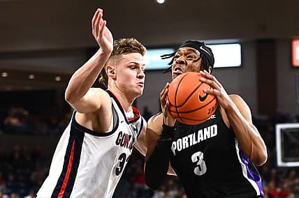Jan 14, 2023; Spokane, Washington, USA; Portland Pilots forward Alden Applewhite (3) shoots the ball against Gonzaga Bulldogs forward Ben Gregg (33) in the first half at McCarthey Athletic Center. Mandatory Credit: James Snook-USA TODAY Sports