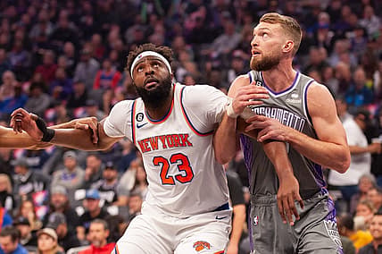 Mar 9, 2023; Sacramento, California, USA; New York Knicks center Mitchell Robinson (23) and Sacramento Kings forward Domantas Sabonis (10) fight for position under the basket during the first quarter at Golden 1 Center. Mandatory Credit: Ed Szczepanski-USA TODAY Sports