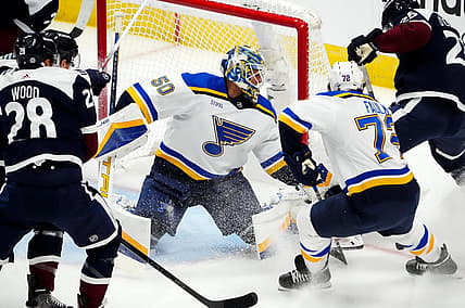 Nov 1, 2023; Denver, Colorado, USA; St. Louis Blues goaltender Jordan Binnington (50) makes a save on Colorado Avalanche right wing Logan O'Connor (25) as defenseman Justin Faulk (72) defends in the first period at Ball Arena. Mandatory Credit: Ron Chenoy-USA TODAY Sports