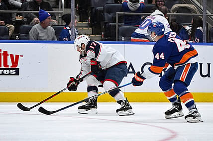 Dec 7, 2023; Elmont, New York, USA; Columbus Blue Jackets right wing Justin Danforth (17) skates past New York Islanders center Jean-Gabriel Pageau (44) during the first period at UBS Arena. Mandatory Credit: John Jones-USA TODAY Sports