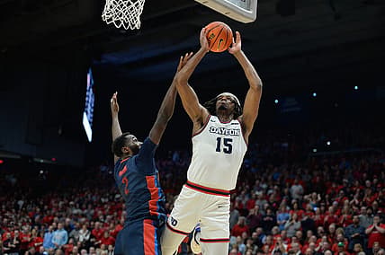 Feb 13, 2024; Dayton, Ohio, USA;  Dayton Flyers forward DaRon Holmes II (15) shoots the ball against Duquesne forward David Dixon (2) during the game at University of Dayton Arena. Mandatory Credit: Matt Lunsford-USA TODAY Sports