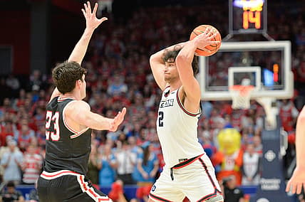Feb 27, 2024; Dayton, Ohio, USA;  Dayton Flyers forward Nate Santos (2) passes the ball against Davidson Wildcats guard Connor Kochera (23) during the second half of the game at University of Dayton Arena. Mandatory Credit: Matt Lunsford-USA TODAY Sports