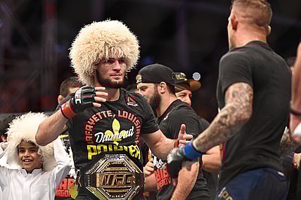 Sep 7, 2019; Abu Dhabi, UAE; Khabib Nurmagomedov (red gloves) greets Dustin Poirier (blue gloves) during UFC 242 at The Arena. Mandatory Credit: Per Haljestam-USA TODAY Sports