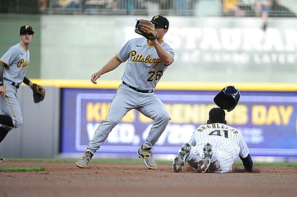 Apr 17, 2021; Milwaukee, Wisconsin, USA; Milwaukee Brewers center fielder Jackie Bradley Jr. (41) slides safely into second base ahead of the tag by Pittsburgh Pirates second baseman Adam Frazier (26) in the first inning at American Family Field. Mandatory Credit: Michael McLoone-USA TODAY Sports