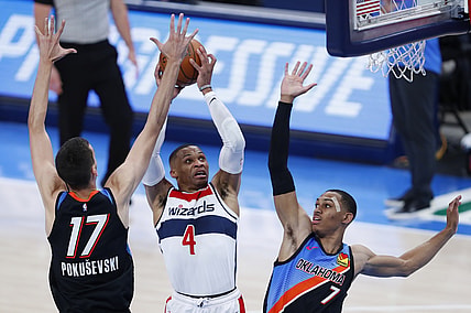 Apr 23, 2021; Oklahoma City, Oklahoma, USA; Washington Wizards guard Russell Westbrook (4) drives to the basket between Oklahoma City Thunder forward Aleksej Pokusevski (17) and forward Darius Bazley (7) during the third quarter at Chesapeake Energy Arena. Mandatory Credit: Alonzo Adams-USA TODAY Sports