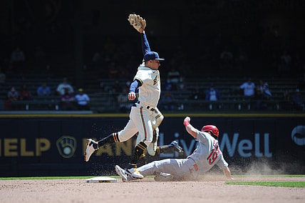 May 13, 2021; Milwaukee, Wisconsin, USA;  Milwaukee Brewers third baseman Luis Urias (2) is pulled off the bag as St. Louis Cardinals third baseman Tommy Edman (19) steals second base in the fifth inning at American Family Field. Mandatory Credit: Michael McLoone-USA TODAY Sports