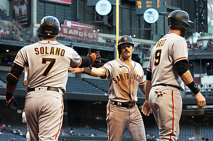 May 25, 2021; Phoenix, Arizona, USA; San Francisco Giants third baseman Evan Longoria (10) celebrates with shortstop Donovan Solano (7) and first baseman Brandon Belt (9) after scoring a run in the first inning against the Arizona Diamondbacks at Chase Field. Mandatory Credit: Rick Scuteri-USA TODAY Sports