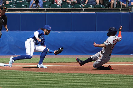 Jun 5, 2021; Buffalo, New York, USA; Toronto Blue Jays shortstop Bo Bichette (11) tags out Houston Astros second baseman Jose Altuve (27) attempting to steal third base during the first inning at Sahlen Field. Mandatory Credit: Timothy T. Ludwig-USA TODAY Sports