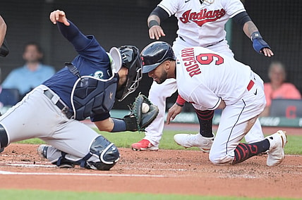 Jun 11, 2021; Cleveland, Ohio, USA; Seattle Mariners catcher Jose Godoy (78) tags out Cleveland Indians left fielder Eddie Rosario (9) during the first inning at Progressive Field. Mandatory Credit: Ken Blaze-USA TODAY Sports