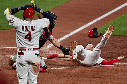 Jun 14, 2021; St. Louis, Missouri, USA;  St. Louis Cardinals center fielder Dylan Carlson (3) is tagged out at home by Miami Marlins catcher Jorge Alfaro (38) as catcher Yadier Molina (4) reacts during the third inning at Busch Stadium. Mandatory Credit: Jeff Curry-USA TODAY Sports