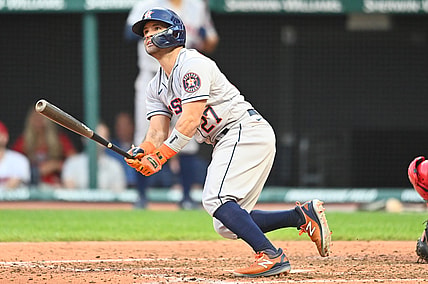 Jul 1, 2021; Cleveland, Ohio, USA; Houston Astros second baseman Jose Altuve (27) hits a grand slam during the fifth inning against the Cleveland Indians at Progressive Field. Mandatory Credit: Ken Blaze-USA TODAY Sports