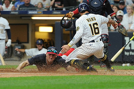 Aug 21, 2021; Milwaukee, Wisconsin, USA;  Washington Nationals first baseman Ryan Zimmerman (11) races to tag out Milwaukee Brewers second baseman Kolten Wong (16) at home plate in the fifth inning at American Family Field. Mandatory Credit: Michael McLoone-USA TODAY Sports