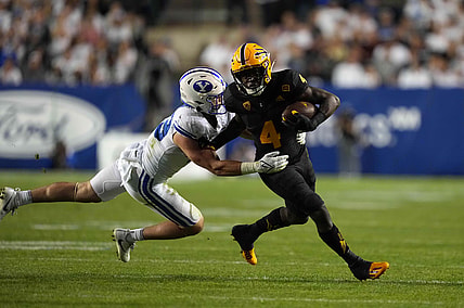Sep 18, 2021; Provo, Utah, USA; Arizona State Sun Devils running back Daniyel Ngata (4) is defended by BYU Cougars linebacker Payton Wilgar (49) in the second half at LaVell Edwards Stadium. Mandatory Credit: Kirby Lee-USA TODAY Sports
