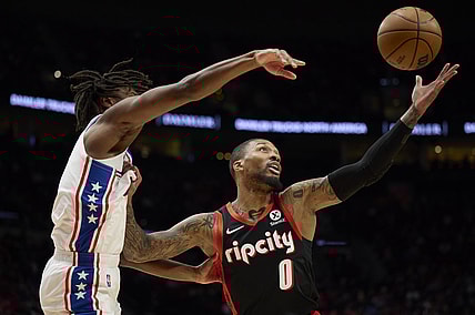 Nov 20, 2021; Portland, Oregon, USA; Philadelphia 76ers guard Tyrese Maxey (0) defends Portland Trail Blazers guard Damian Lillard (0) during the first half at Moda Center. Mandatory Credit: Troy Wayrynen-USA TODAY Sports