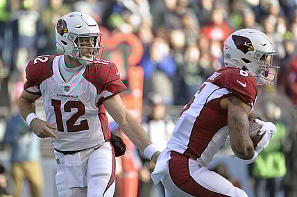 Nov 21, 2021; Seattle, Washington, USA; Arizona Cardinals quarterback Colt McCoy (12) hands the ball off to Arizona Cardinals running back James Conner (6) during the first half against the Seattle Seahawks at Lumen Field. Mandatory Credit: Steven Bisig-USA TODAY Sports