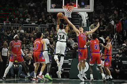 Nov 24, 2021; Milwaukee, Wisconsin, USA; Milwaukee Bucks forward Giannis Antetokounmpo (34) puts up a shot against Detroit Pistons center Luka Garza (55) in the first half at Fiserv Forum. Mandatory Credit: Michael McLoone-USA TODAY Sports