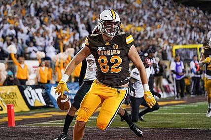 Sep 28, 2019; Laramie, WY, USA; Wyoming Cowboys tight end Jackson Marcotte (82) runs for a touchdown against UNLV Rebels defensive back Jericho Flowers (7) during the second quarter at Jonah Field War Memorial Stadium. Mandatory Credit: Troy Babbitt-USA TODAY Sports